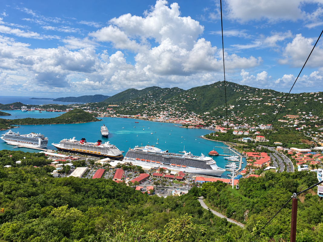 Scenic view of St. Thomas harbor with blue water, hills, and boats