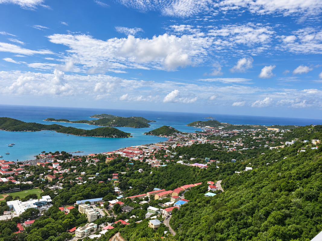 Scenic overlook of St. Thomas with blue sky, hills, and ocean